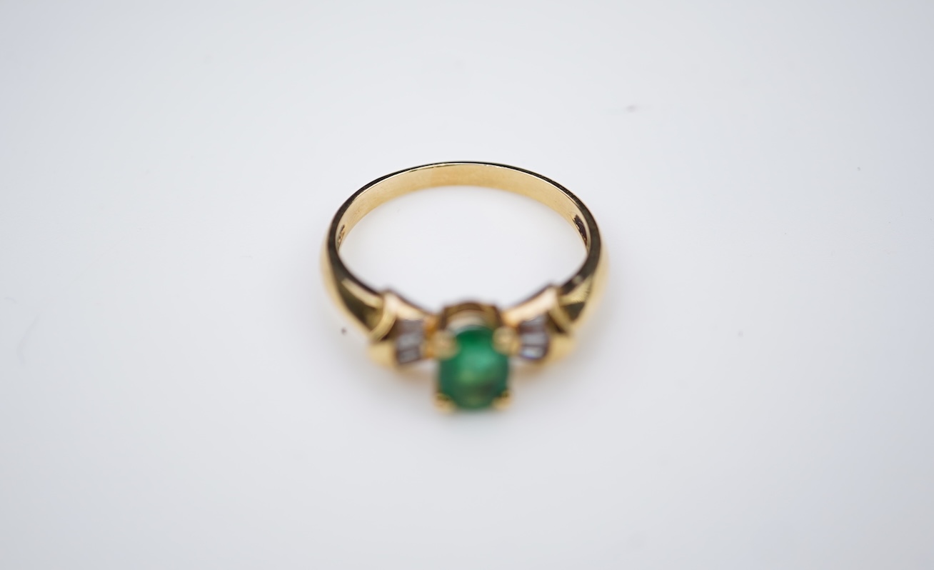 An emerald and diamond ring
